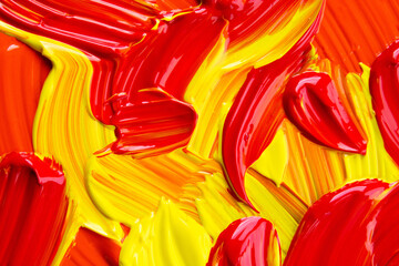 Top view of red yellow paint brush strokes on surface, background, texture 