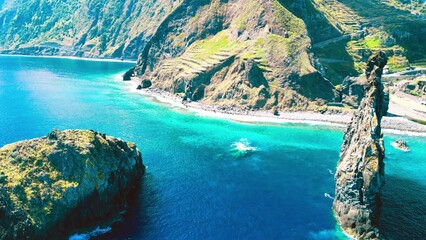 Aerial view of tall lava rocks in ocean, islet towers in Ribeira da Janela, Madeira, Portugal