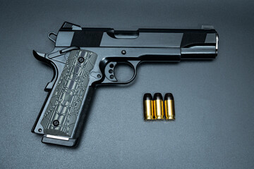 Custom pistol model m1911 with skull punisher on the handle.