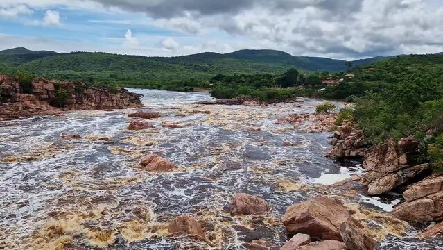 Donana Waterfall in Paraguassu River with dark waters due to iron ore in Andarai, Chapada Diamantina, Bahia in Brazil