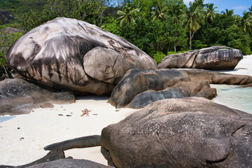 Mahe Seychelles 11.02.2023 Huge rock boulders, woman relaxing on the beach