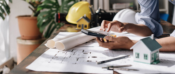 Image of engineer drawing a blue print design building or house, An engineer workplace with...
