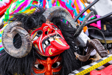 Traditional wooden mask of a devil with horns and tongue during Gody Zywieckie - traditional winter parade of 'Dziady', 'Jukace', folk custom in Zywiec region, Poland.