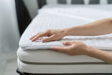 woman select new mattress cover in furniture store, closeup