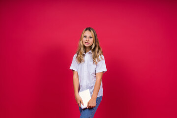 Child making notes. Kids dreams.Isolated on red background. Education, Kid back to school.