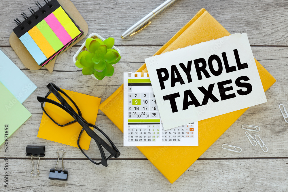 Aufkleber payroll taxes . multicolored stickers and yellow notepad with notepad page with text