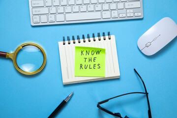 Know The Rules on sticky note with a business objects on the blue background.