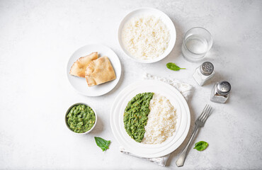 Obraz na płótnie Canvas Spinach dahl with rice in a plate