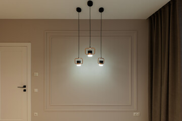A modern lamp in a gray room. Interior