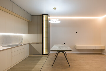 Modern kitchen in the interior of a new apartment in beige tones