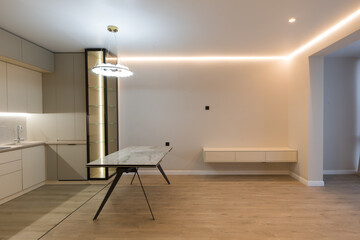 Modern kitchen in the interior of a new apartment in beige tones
