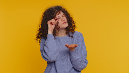 Need some more, please give me. Curly haired woman showing a little bit gesture with sceptic smile,...
