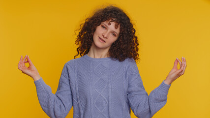 Keep calm down, relax, inner balance. Curly haired woman breathes deeply with mudra gesture, eyes...
