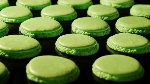 Baking green macaroons in electric oven. Timelapse of growing macarons. Delicious dessert. Process of cooking macaroons. Close-up in 4K, UHD