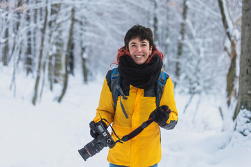 red haired woman in the snow walking with the forest in the background, woman taking photos in the snow, copy space, white background