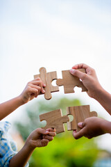 jigsaw and hands Combine the power of unity, teamwork, teamwork.