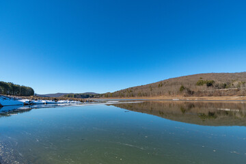 Fototapeta na wymiar Winter lake landscape calm sunny day during winter season