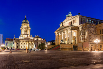 Fototapeta na wymiar Concert Hall (Konzerthaus) and New Church (Deutscher Dom or Neue Kirche) on Gendarmenmarkt square at night in Berlin, Germany