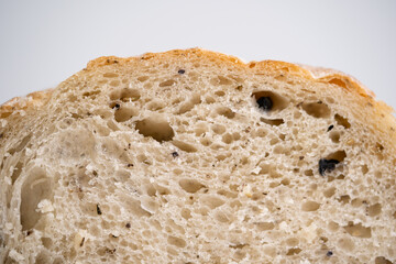 Close up Olive sourdough bread cross section view with isolated white background.