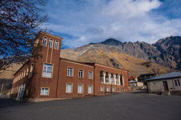 Kazbegi, Georgia : 10-11-2022 : Village Of Gergeti In Georgia, with the beautiful Caucasus mountain peaks and meadow surrounded