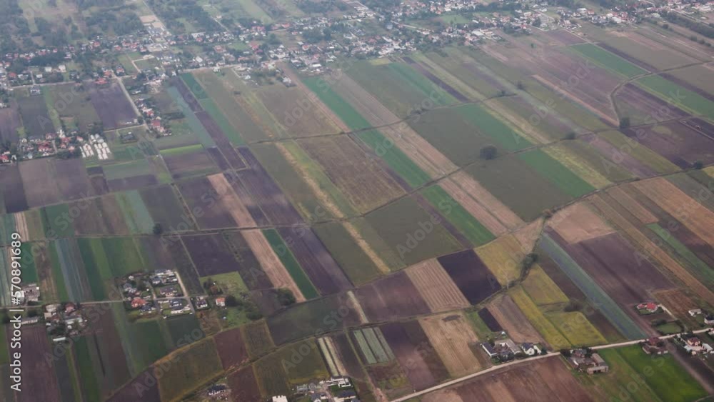 Wall mural Colorful fields seen through the plane window near Warsaw airport, 4k video