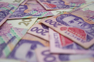 Obraz premium Ukrainian money background. banknotes with a face value of 200 hryvnia money background. Ukrainian money. Business concept. Background with hryvnia.
