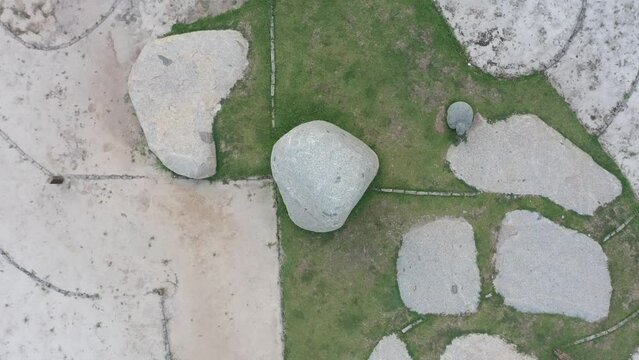 the drone camera moves up, above the boulders, the ancient site on Bumi Ragem Sai Mangi Wawai, Lampung Indonesia.