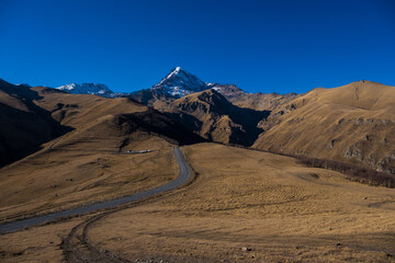 Georgia : 10-11-2022 : Country of Georgia, Kazbegi, Panoramic landscape of beautiful natural mountains, view of amazing Caucasus mountain peaks and meadows in Kazbegi national park