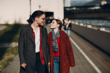 Caucasian young couple walking in the street at Valentines day.