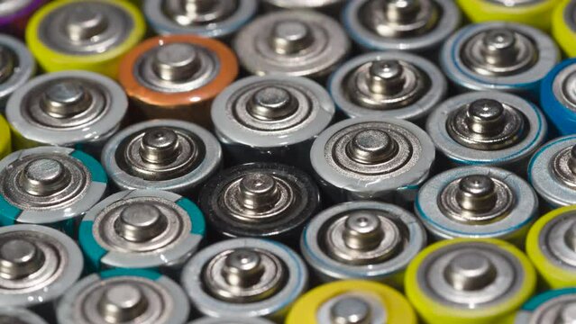 Preparing Batteries for Recycling. Dense array of AA batteries moving with slight rotation close-up