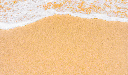 Fototapeta na wymiar Sand beach seaside, tide coastline with white foamy on daylight in summer season 
