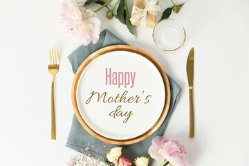 Happy Mother's day concept. Beautiful table setting with golden cutlery and peony flowers