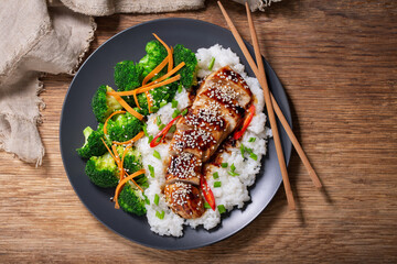 Plate of teriyaki chicken with vegetables and rice, top view