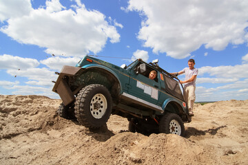 Fototapeta na wymiar SUV rides on a sand quarry