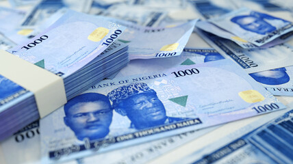 close up of new 1000 Nigerian naira notes spread on table. 3d rendering of money scattered on surface