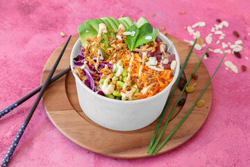Tuna poke bowl (edamame beans, carrot, rice, avocado, red cabbage, edamame beans, chives) on the red background - obrazy, fototapety, plakaty