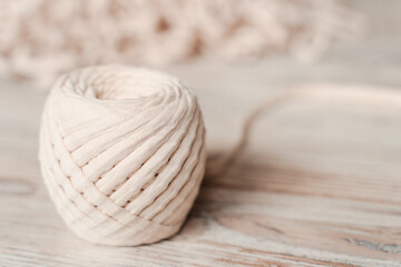 Skein of threads of beige noodle yarn, close-up