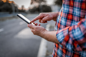 Handsome Businessman in the Street with Mobile Phone