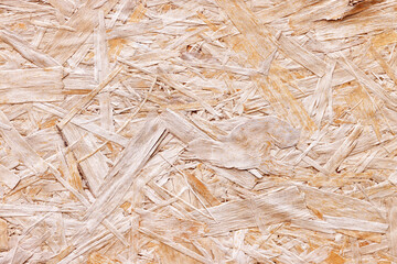 OSB board texture. Brown wooden background. Simple pressed chipboard pattern. Chip board background. Brown wood texture