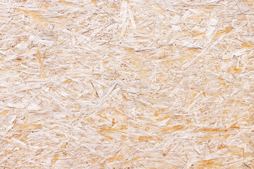 OSB board texture. Brown wooden background. Simple pressed chipboard pattern. Chip board background. Brown wood texture