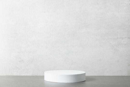 Abstract empty white podium on grey background.