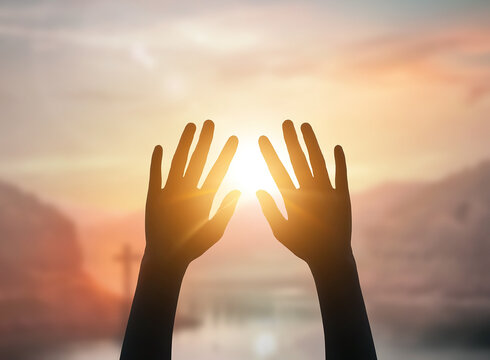 Hands reach for the sky to light in the form of a cross background