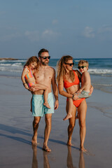 Happy family with little kids enjoying time at sea in exotic country.