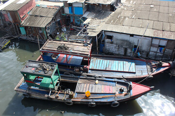 Fototapeta na wymiar portrait of traditional fishing boats on a dirty river