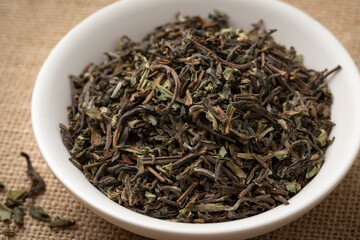 Bowl with organic Nepal Oolong Jun Chiyabari dried tea leaves