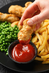 Irish battered sausages with potato fries, green peas and ketchup