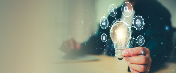 Hand holding light bulb for creative idea concept or innovation, inspiration, innovative of technology in analyzing global marketing online business data management services to target growth concept.