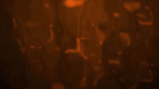 4K background abstract blurred orange with liquefaction happening in the background. Melting stained glass effect stock video. Slowly dissolving and running down fluid against light beams.