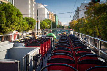 View from open roof of red, turistic hop on bus with tourists inside. Vacation, travel concept