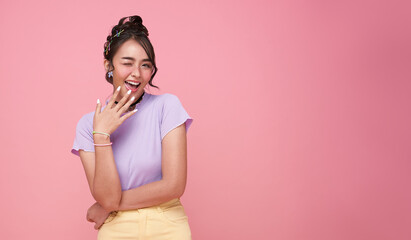 Young Asian teenage girl surprised excited isolated on pink background.